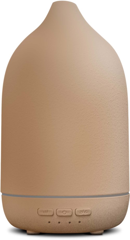 En beige, rund diffuser med knappar längst ner. Det ser ut som en liten luftfuktare eller luftrenare.