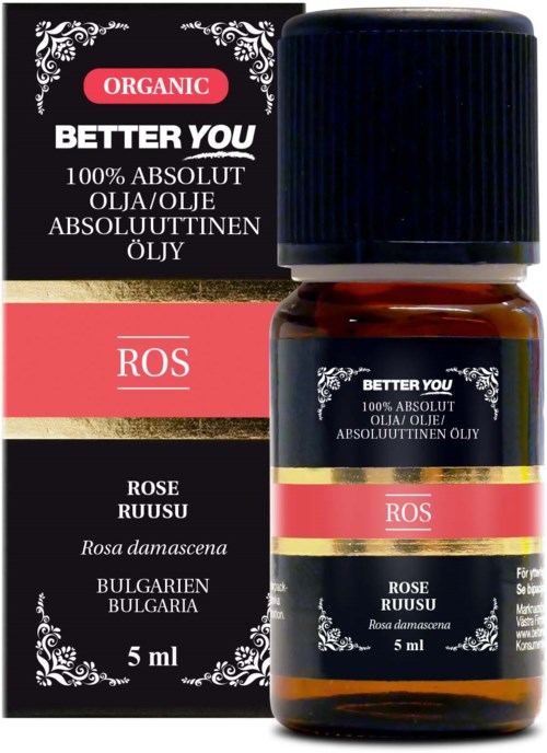 En liten brunt flaska med rosens essentiella olja, svart och röd etikett, och en matchande box bredvid.