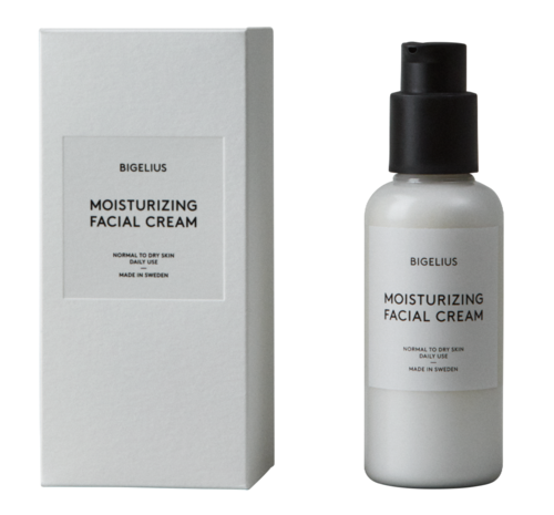 En vit flaska med pump och en box, båda märkta Bigelius Moisturizing Facial Cream för torr hud.