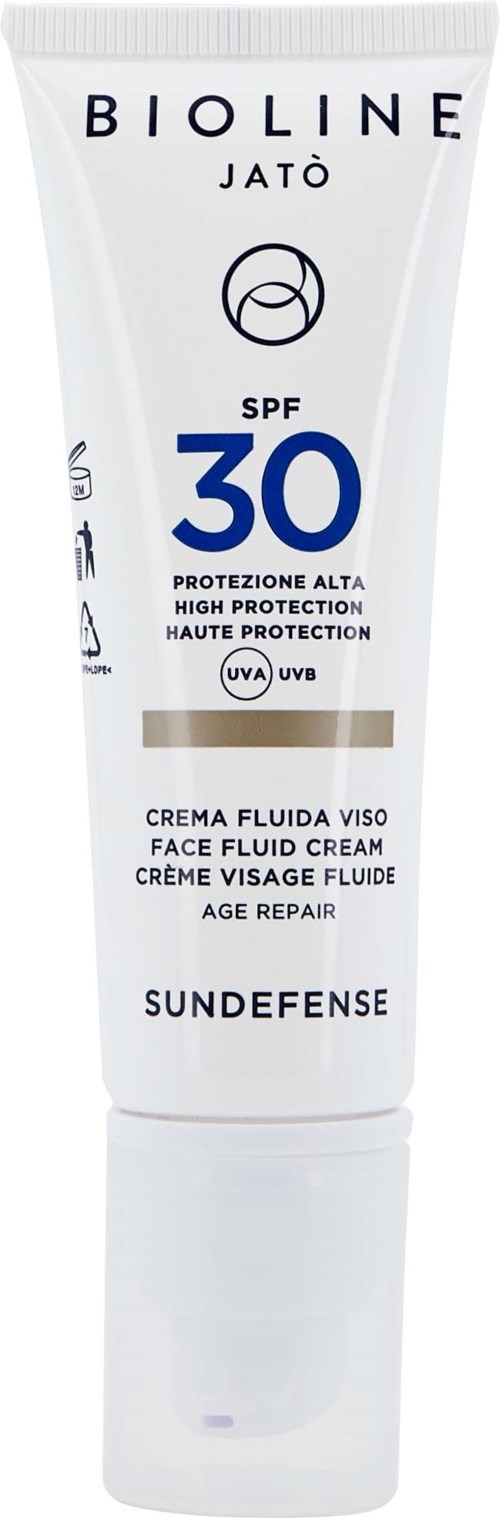 En vit tub med ansiktskräm med SPF 30 för högt skydd, märkt på flera språk och för åldersreparation.