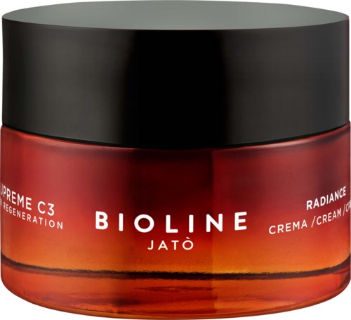 En röd krämglas med svart lock märkt Bioline Jatò, Radiance-kräm för förnyelse.