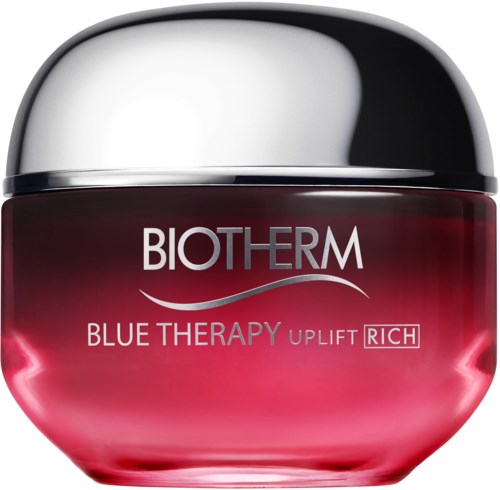 A jar of Biotherm Blue Therapy skin cream with a shiny silver lid, red and blue label.