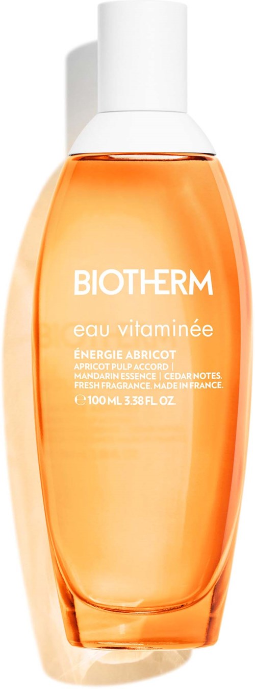 En Biotherm hudpleieflaske med oransje væske og hvit hette, merket Eau Vitaminee med aprikosenergi.