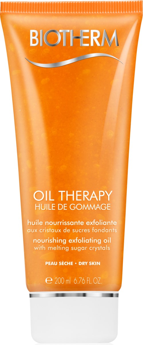 En klar orange tub med Biotherm Oil Therapy närande exfolierande olja för torr hud med sockercristaller.