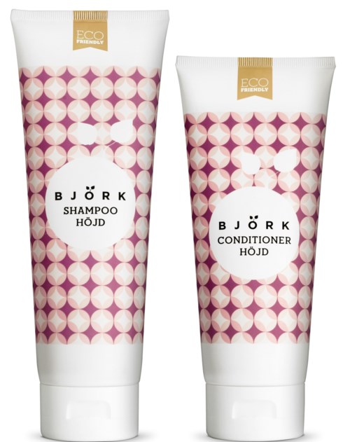 To hårplejeprodukter i tube, mærket 'Shampoo' og 'Conditioner' med pink og hvidt geometrisk mønster, markeret miljøvenlig.