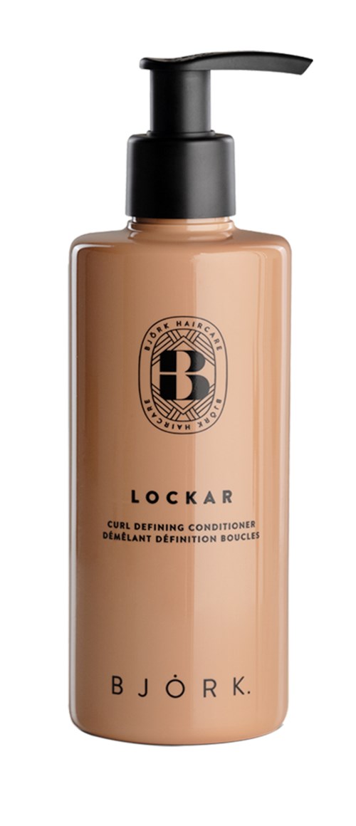 A beige bottle with a black pump, labeled Lockar and Bjork, likely a hair conditioner or similar product.