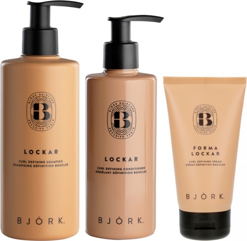 Three hair care products: shampoo, conditioner, and styling cream, in beige bottles with black pumps and labels.