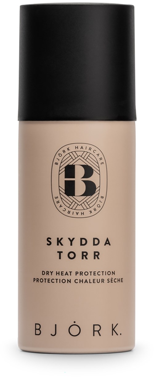 En flaska med svart lock, beige kropp, och märkt som Björks torra värmebeskydd för hår.