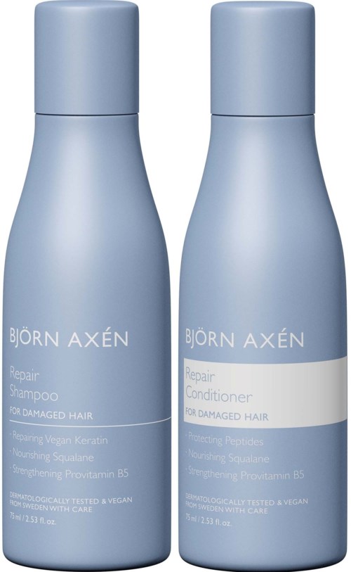 Two light blue bottles of Björn Axén haircare, one for shampoo and one for conditioner, for damaged hair.