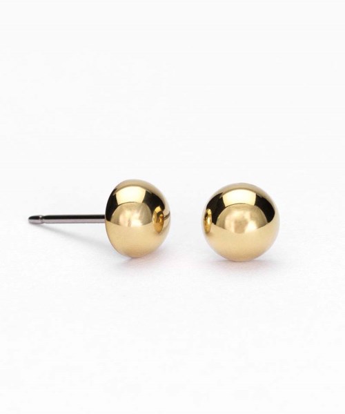 Two shiny gold ball earrings on a white background, one with a backing pin.