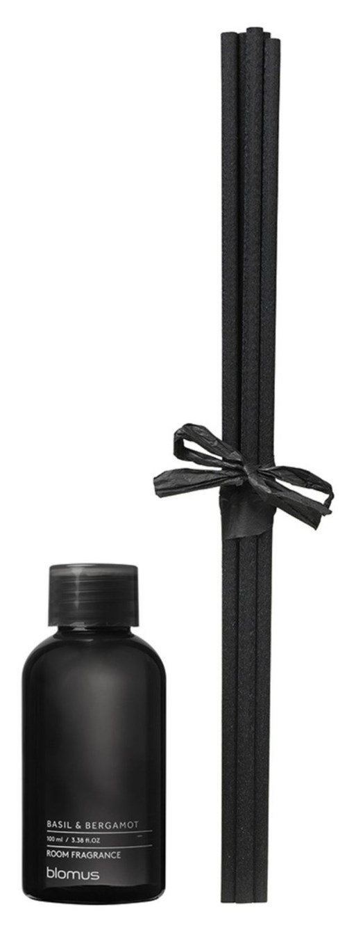 A black bottle of fragrance and black incense sticks tied with a black ribbon.