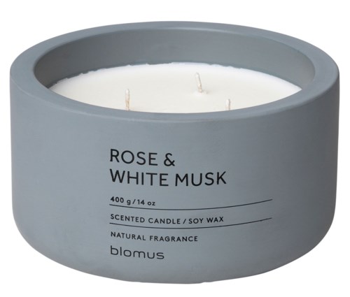 A grey round candle jar labeled 'Rose & White Musk' with three wicks inside.