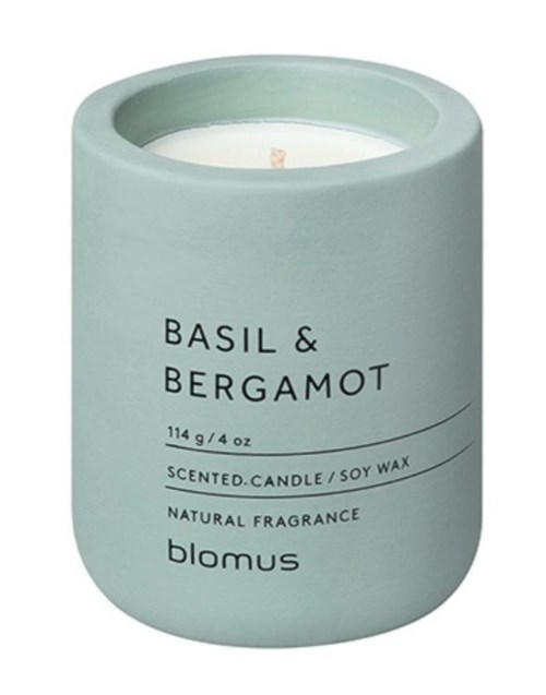 A light blue scented candle made of soy wax, with a focus on basil and bergamot scent, by Blomus.
