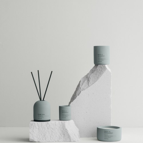 Minimalist skincare products arranged on white textured blocks, with a simple white background for a clean look.