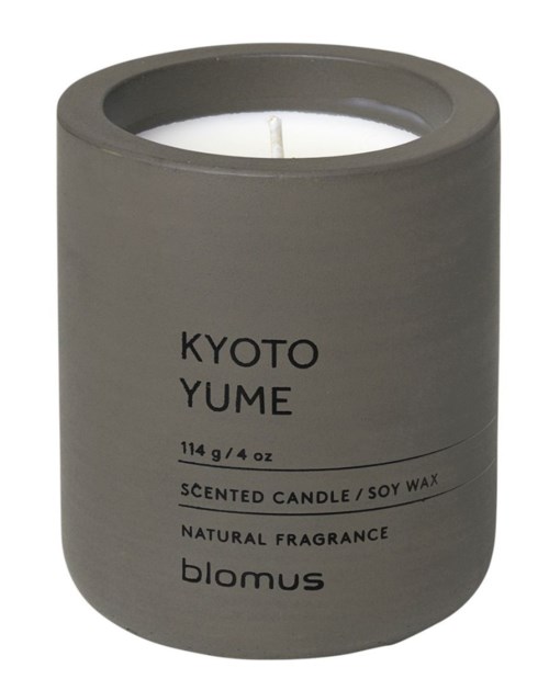 A gray candle container with black text, labeled 'Kyoto Yume,' made of soy wax and scented fragrance.