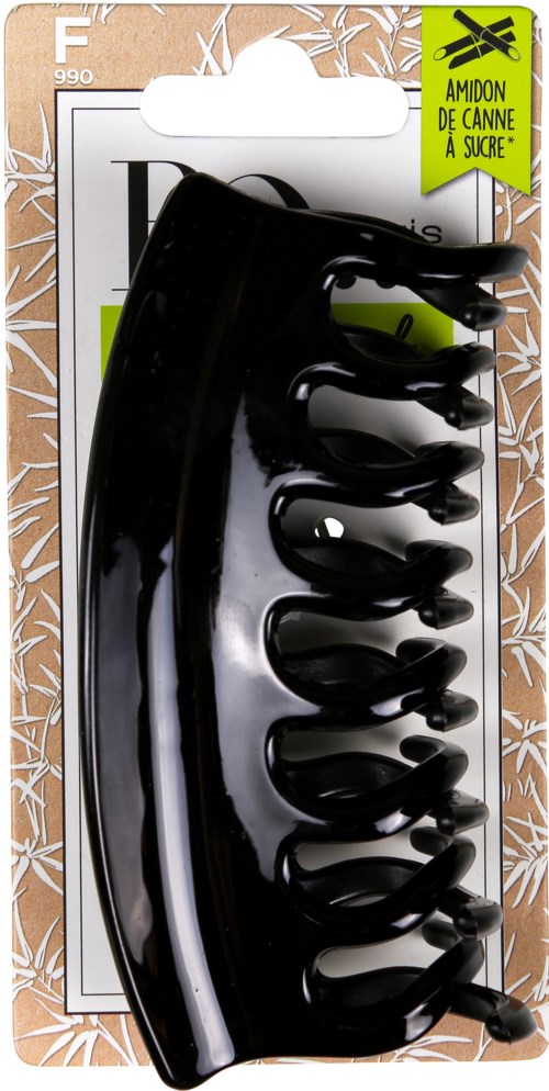 Een zwarte plastic haarclip in verpakking met groene en witte labels, ontworpen om haar vast te houden.