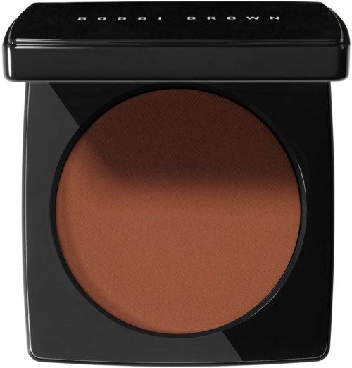 A BOBBI BROWN compact with a brown pressed powder. The compact is black with white text on the lid.