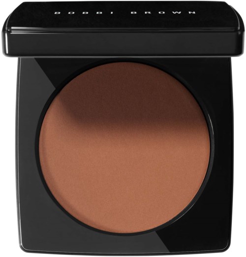 A round makeup compact with a brown powder inside and a black lid with white text.