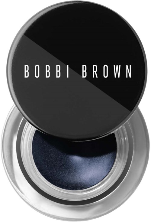 Deksel van Bobbi Brown crème oogschaduw in zwart met witte letters. De open container toont donker marineblauwe oogschaduw.