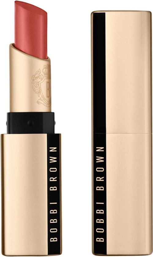 A gold-colored lipstick tube with black stripe, partially open, showing pink lipstick inside.