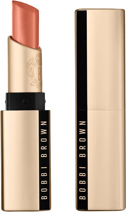 A beige lipstick in a gold case with black lettering, one slip of lipstick is visible. The case is shiny and elegant.