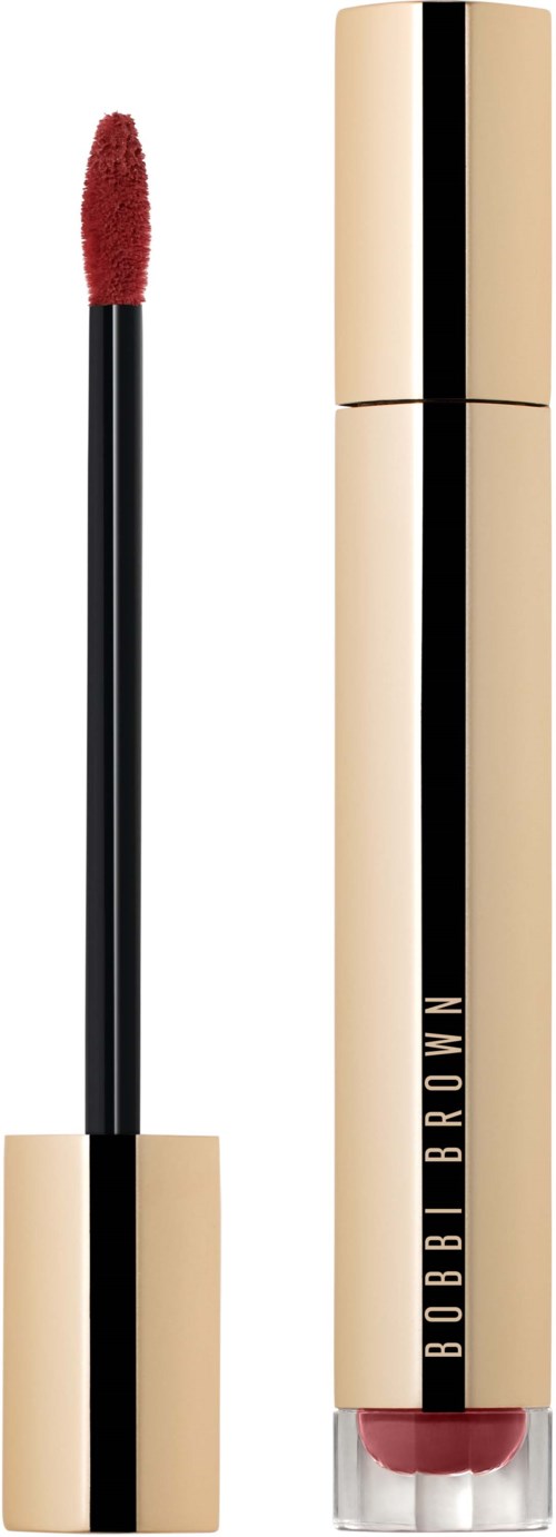 A lip gloss tube and applicator with a gold and black design. The brand name Bobbi Brown is on the tube.