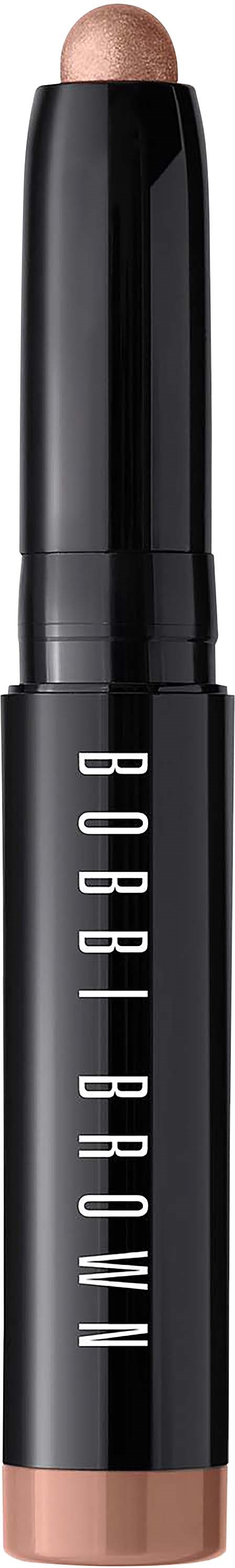 Een Bobbi Brown make-upstift met een beige tint boven en onder, met de merknaam op het zwarte lichaam.
