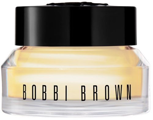 Ein kleiner Behälter mit gelber Creme und schwarzem Deckel, beschriftet 'BOBBI BROWN'.