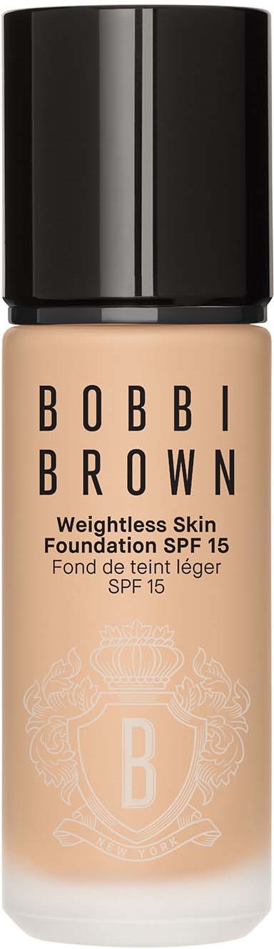 butelka podkładu Bobbi Brown z czarną nakrętką i beżową cieczą. Tekst mówi, że to Weightless Skin Foundation SPF 15.