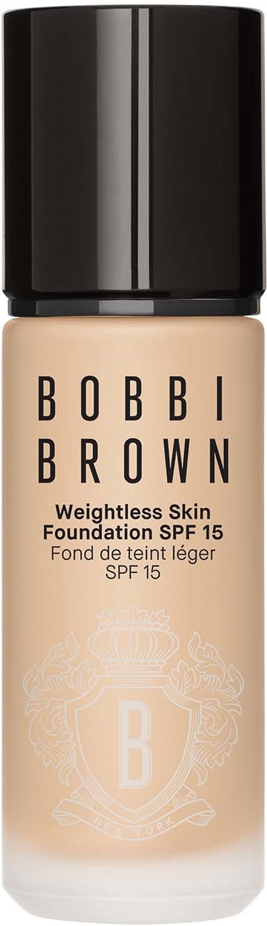 En foundationflaska med svart lock, beige vätska inuti och svart text som lyder Bobbi Brown, SPF 15.