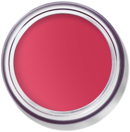 En rund behållare med rosa till röd makeup-kräm inuti. Silverlocket reflekterar ljus och omger krämen.