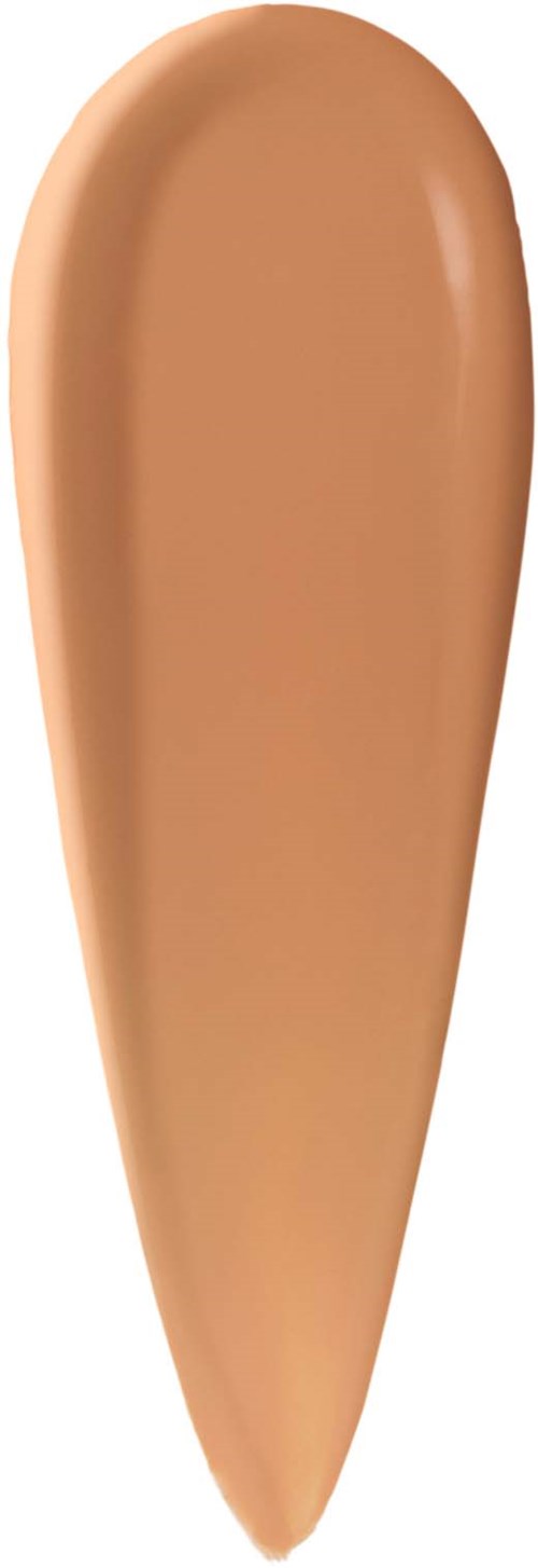 A teardrop-shaped swatch of beige foundation or concealer. Smooth texture with a slight sheen.
