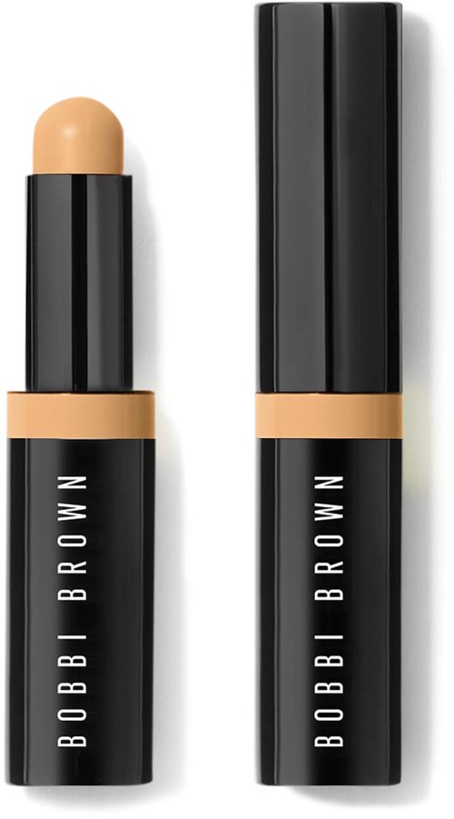 Ein Bobbi Brown Make-up-Stift mit beigefarbener Substanz, schwarz-beige Verpackung. Beide sind geöffnet.