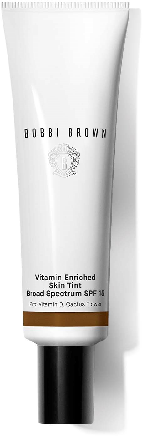 En vit tub med svart lock, märkt Robbi Brown, Vitamin Berikad Hudfärg, SPF 15, med en brun stripe.