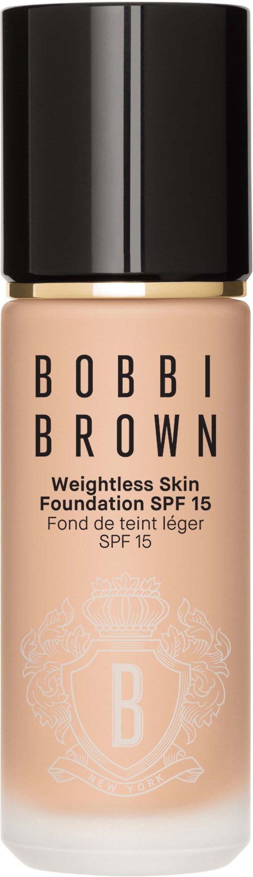 En Bobbi Brown foundationflaska med svart lock och beige vätska i.