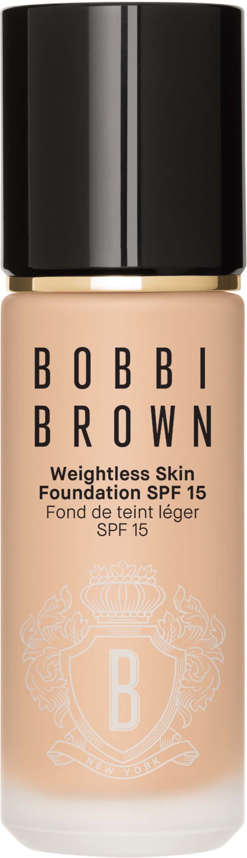 En foundationflaska med svart kork, ljusbeige färg, och Bobbi Brown-logotyp och text.