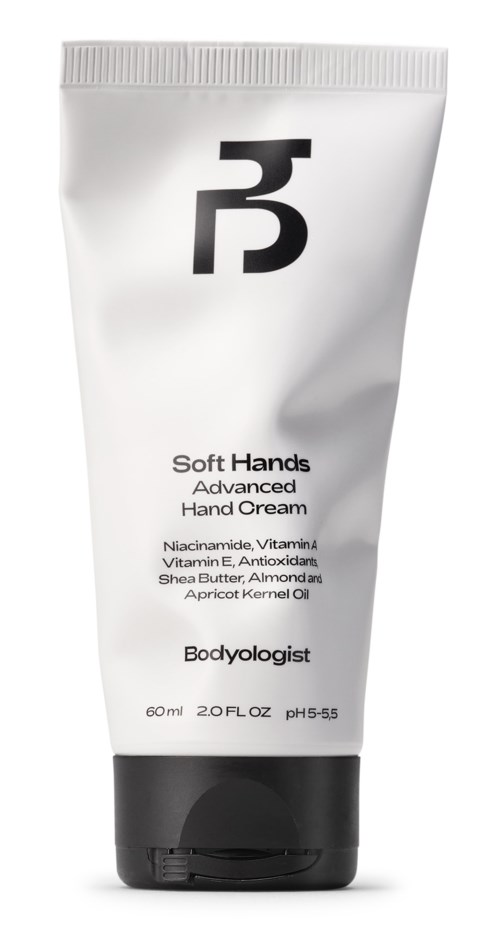 Ein weißer Tuben fortgeschrittene Handcreme mit schwarzem Logo und Text, zeigt Inhaltsstoffe wie Sheabutter und Mandelöl.