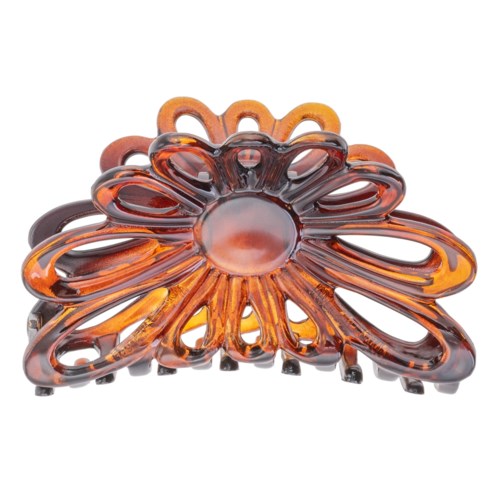 En stor orangebrun hårklemme formet som en blomst med åbne blade og en skinnende midte.