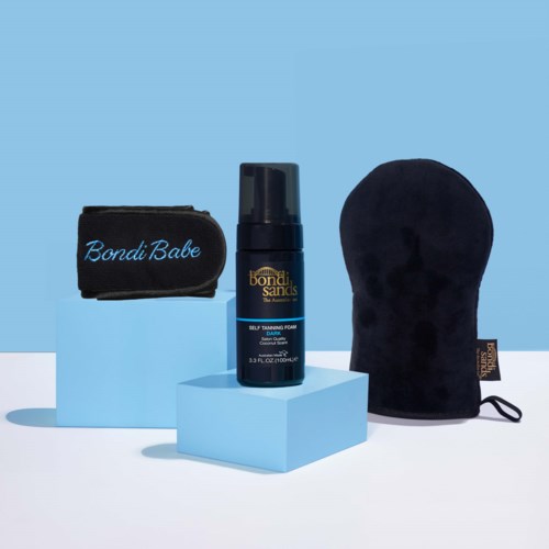 Skincare products with a bag and cloth, displayed on light blue and white blocks, against a light blue background.