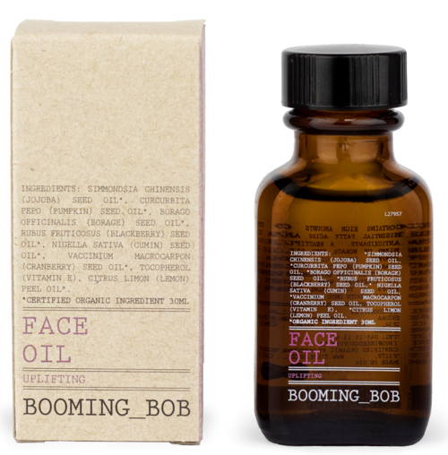 Mała brązowa butelka z napisem 'Face Oil Uplifting' i prostokątne opakowanie wykonane z kartonu z składnikami i nazwą marki 'Booming_Bob'.
