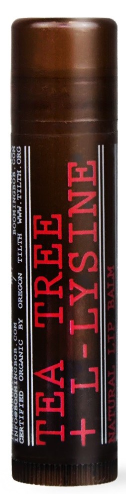 Brązowa rura z napisem 'TREA + LYSTINE' w czerwonym i białym kolorze, prawdopodobnie produkt kosmetyczny lub do pielęgnacji skóry.