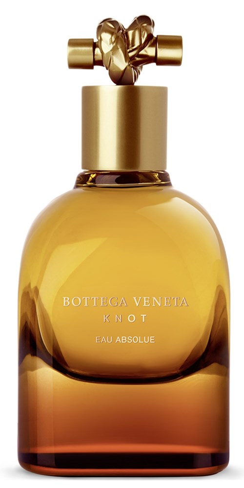 En parfyllflaska med guldkapsel, formad som en knut, märkt Bottica Veneta Knot Eau Absolue, med gul-brun gradientglas.