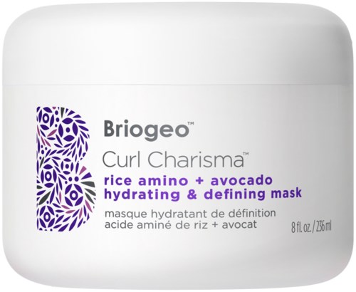 En vit burk med lila och grå text som nämner en hårinpackning med risamino och avokado för återfuktning och definition.
