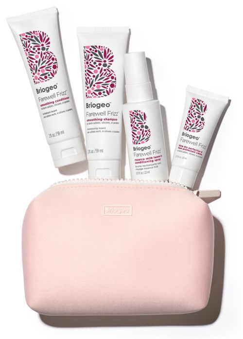 A pink toiletry bag with four Briogeo hair care products inside, including shampoo and conditioner.
