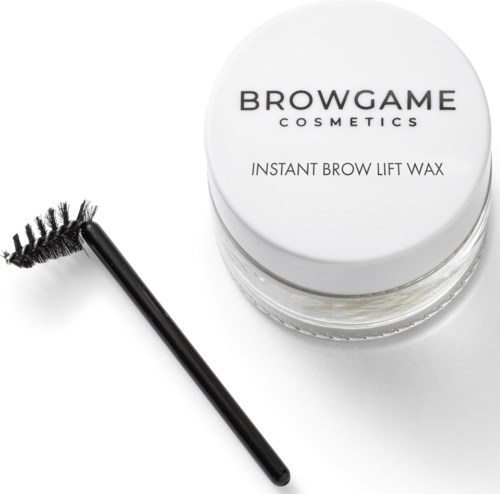 Ein Behälter mit Browgame Cosmetics und Wachs sowie eine Bürste daneben.