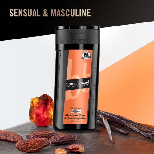 A black bottle of Bruno Banani Absolute Man deodorant with spices and scents, along with nuts and cinnamon sticks.