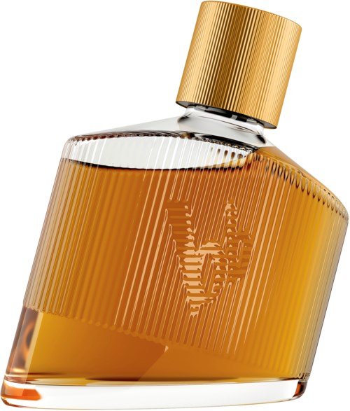 A perfume bottle with a gold cap and a gold label, tilted to the side. It contains amber-colored liquid.