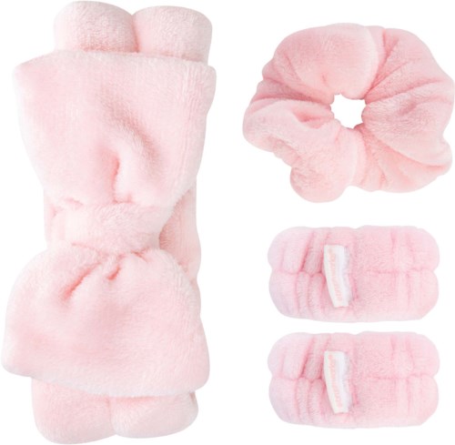 A set of soft pink fuzzy accessories: a large mitten, a scrunchie, and two smaller wristbands.