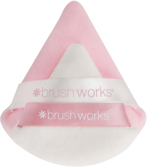 A soft, pink and white cosmetic or skincare item with the 'brush works' brand label on it.