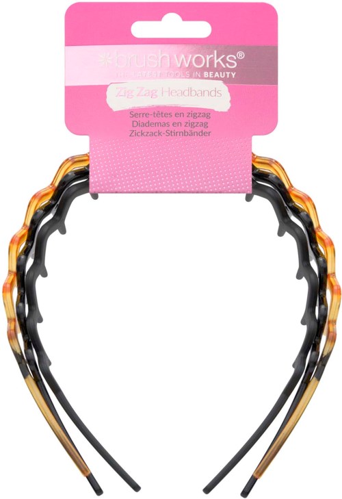 A pair of zigzag-patterned orange and black hairbands attached to pink packaging.